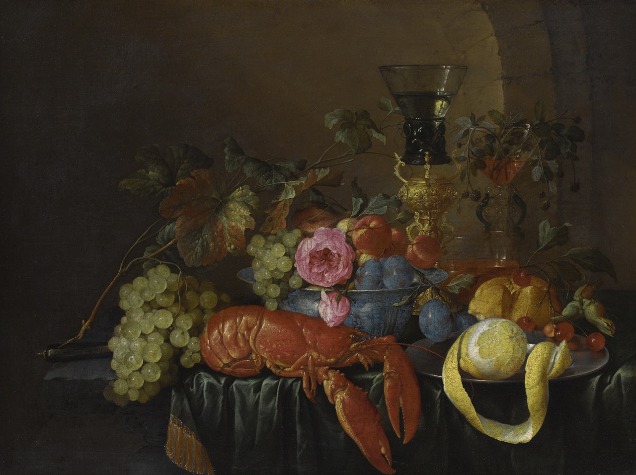STILL LIFE WITH A LOBSTER, A PEELED LEMON ON A PEWTER PLATER, A ROEMER, AND FRUITS ON A STONE LEDGE WITH A GREEN DRAPE by Cornelis de Heem