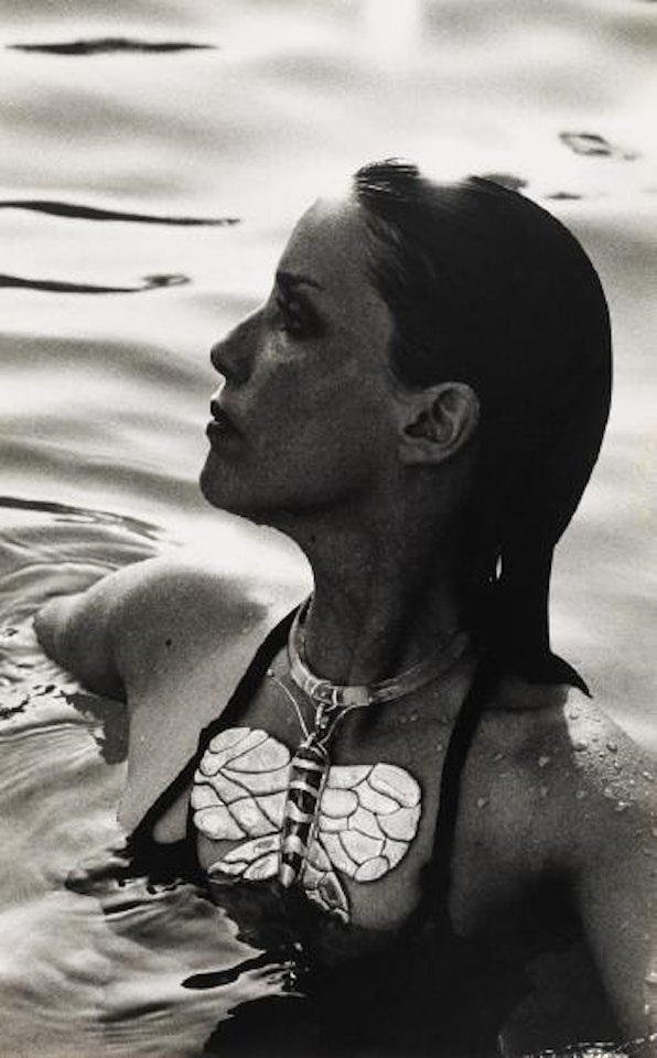 Model in butterfly necklace by Helmut Newton