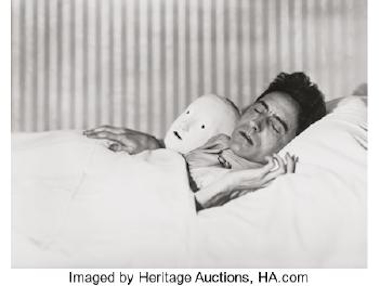 Jean Cocteau lying with the mask of Antigone ,
1927 by Berenice Abbott