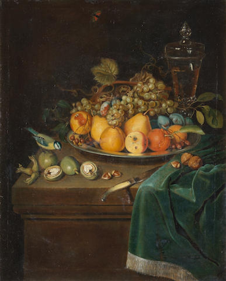 A dish of quince, plums, grapes and other fruit with a glass of wine on a draped table-top with nuts and a blue-tit by German School