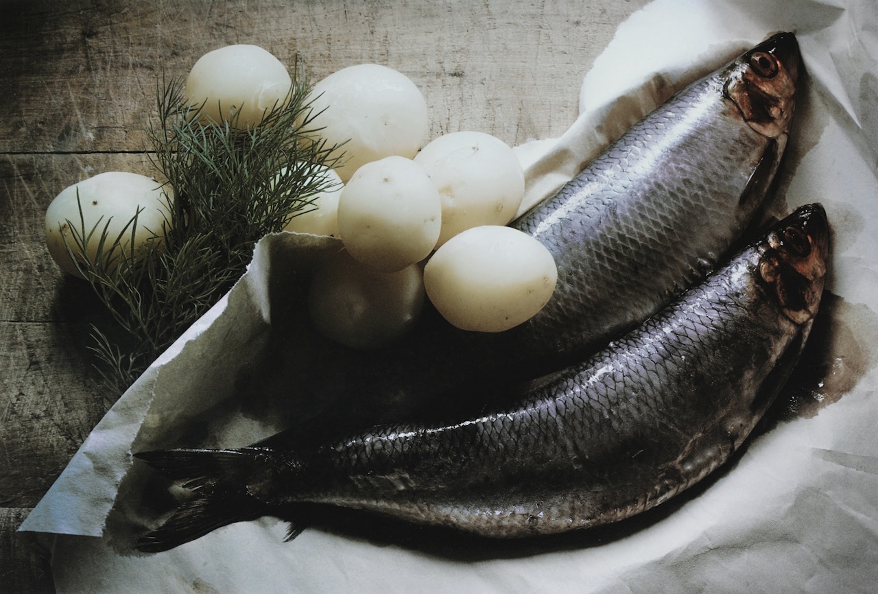 POTATOES AND BALTIC HERRING, SWEDEN, 1964 by Irving Penn
