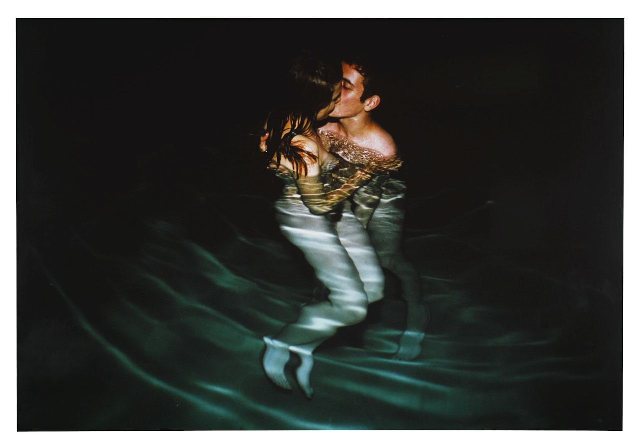 SIMON AND JESSICA KISSING IN YVON'S POOL by Nan Goldin