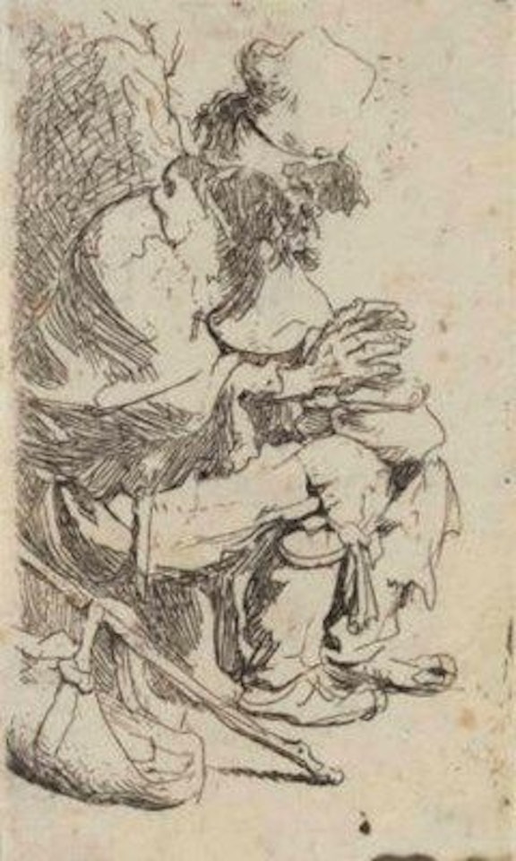 A Beggar seated warming his Hands at a Chafing Dish by Attributed to Rembrandt Harmensz van Rijn