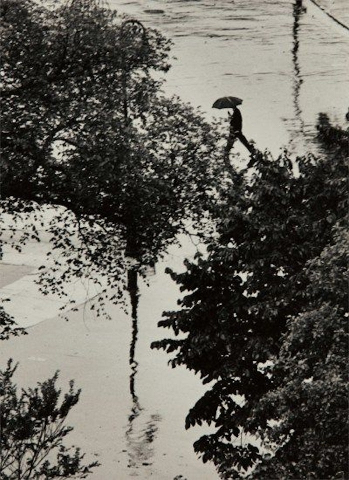 Looking Through Trees at Man with Umbrella, August 2 by André Kertész