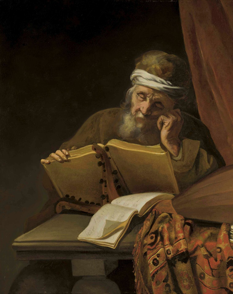 An old man reading at a table with sheets of music, a lute and an oriental carpet, a curtain behind by Attributed to Rembrandt Harmensz van Rijn