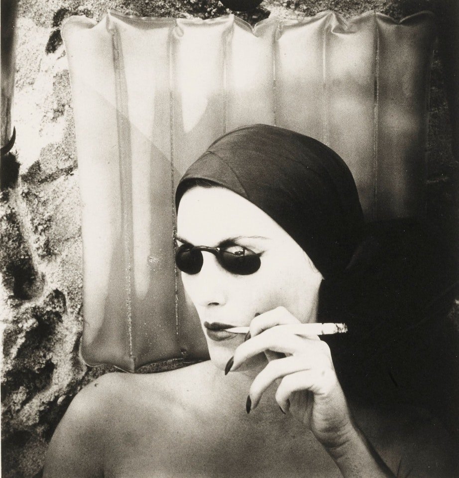 WOMAN ON THE BEACH, SMOKING (MARY JANE RUSSELL, LONG ISLAND, N. Y.) by Irving Penn