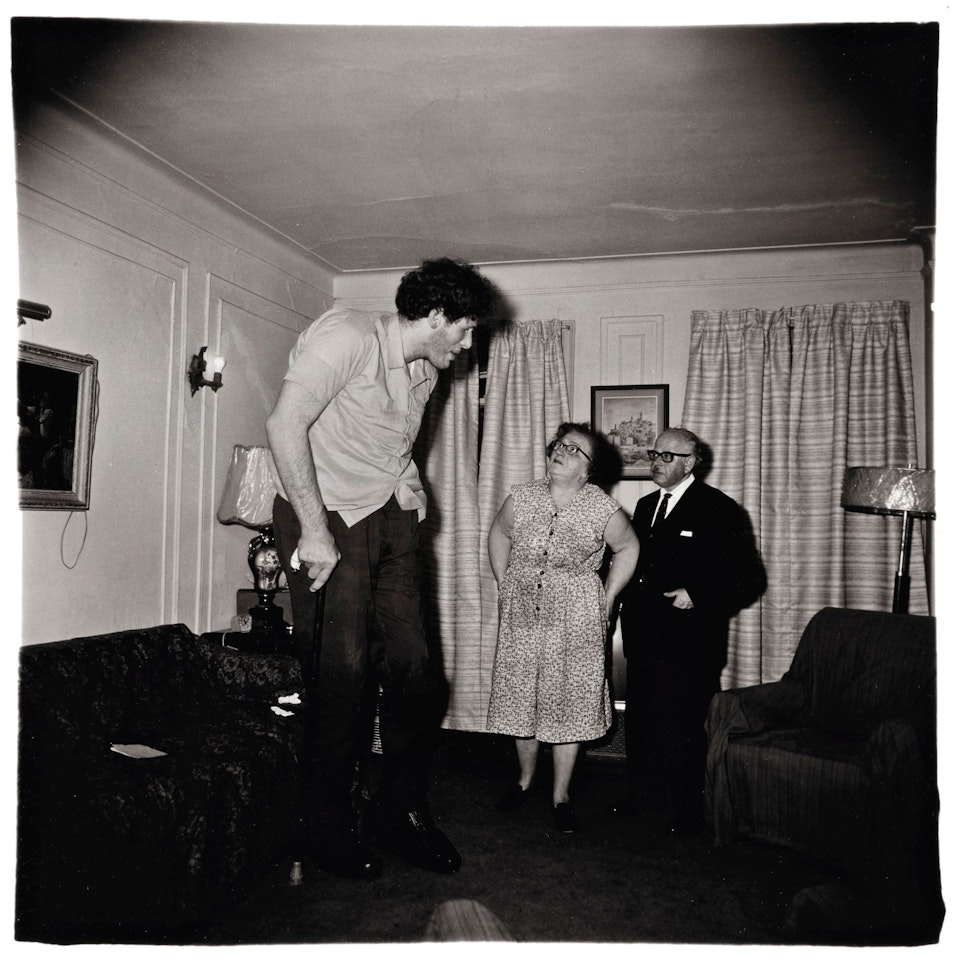 A JEWISH GIANT AT HOME WITH HIS PARENTS IN THE BRONX, N. Y. by Diane Arbus