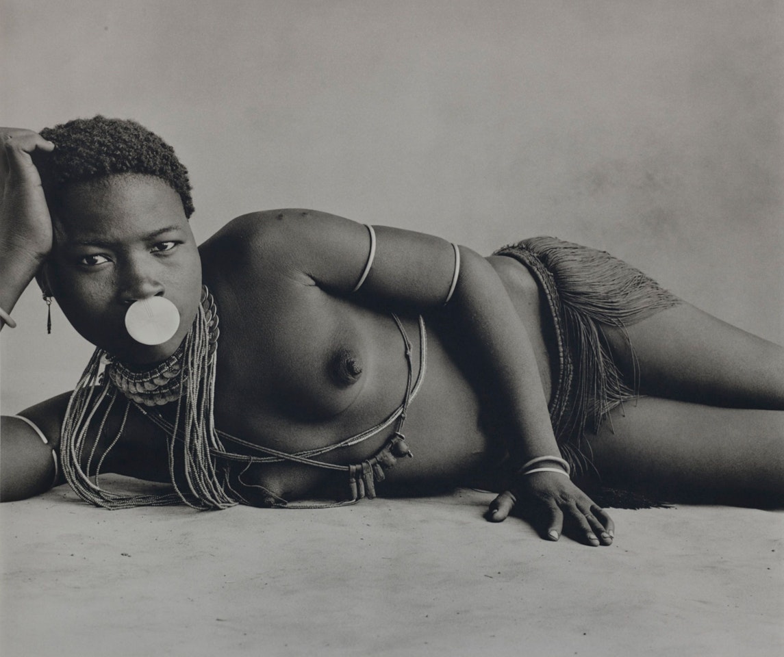 GIRL WITH NOSE DISC by Irving Penn