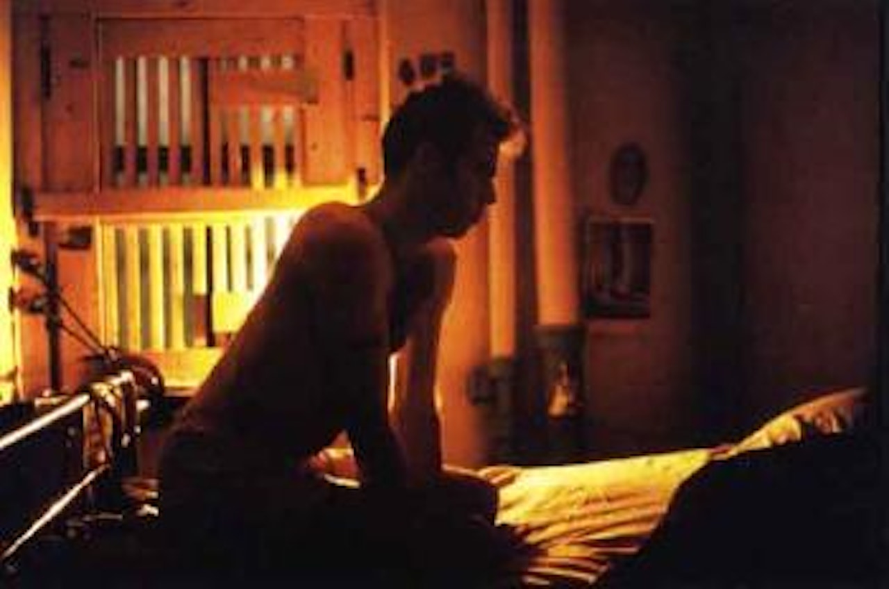 Brian with gold bars, Bowery, New York City by Nan Goldin