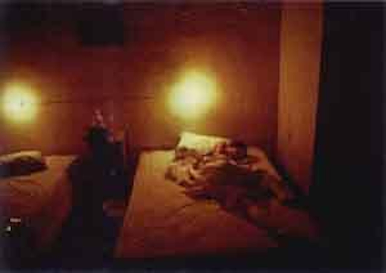 Suzanne in yelow hotel room, Hotel Seville. Merida, Mexico by Nan Goldin