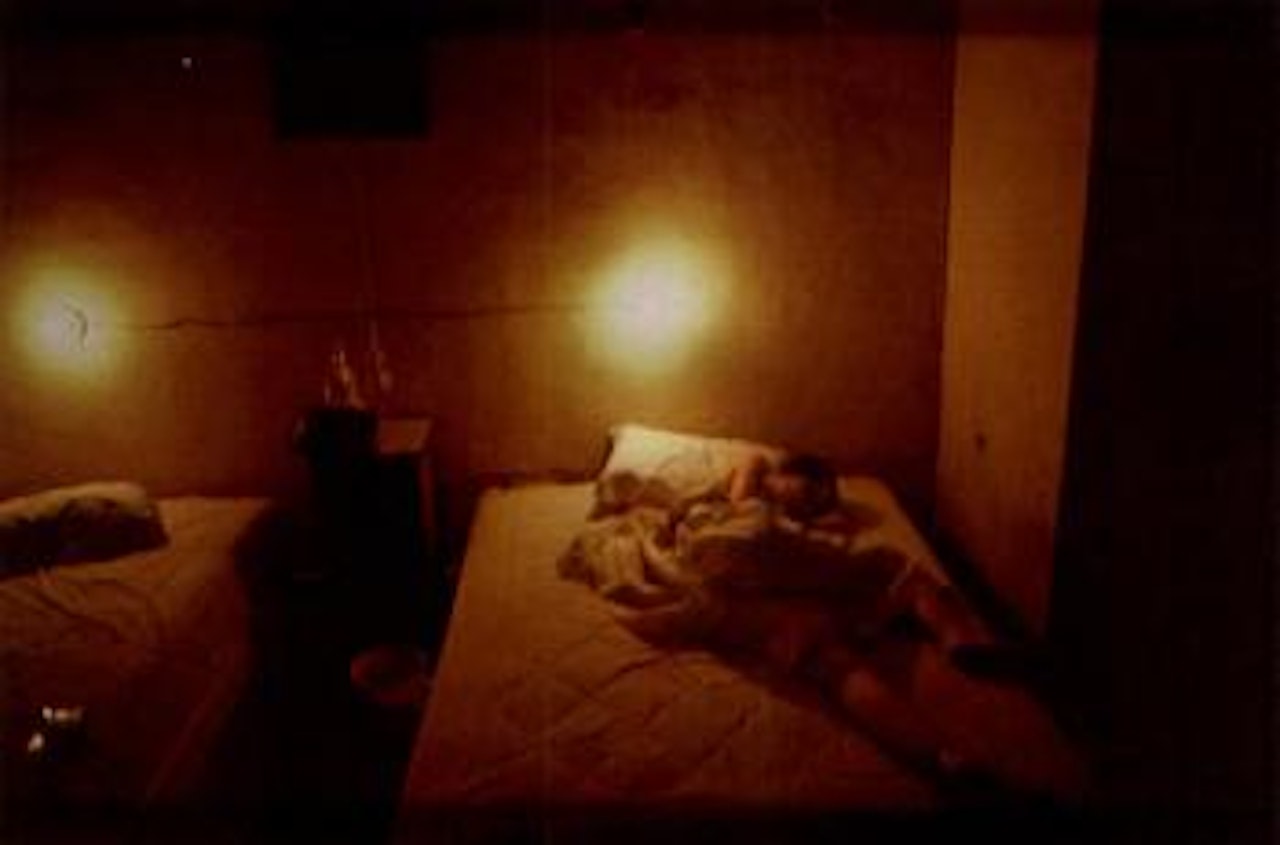 Suzanne in yellow hotel room, Hotel Seville, Merida, Mexico by Nan Goldin