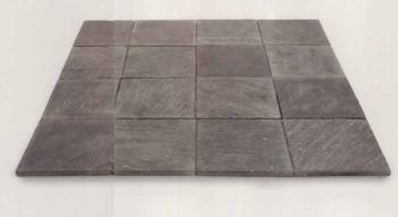 Sixteen pieces of slate by Carl Andre