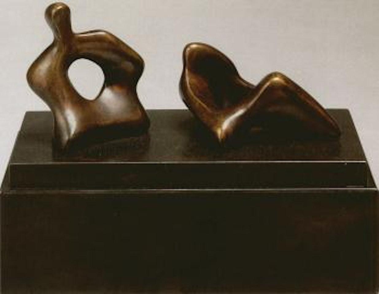 Two piece reclining figure with holes by Henry Moore