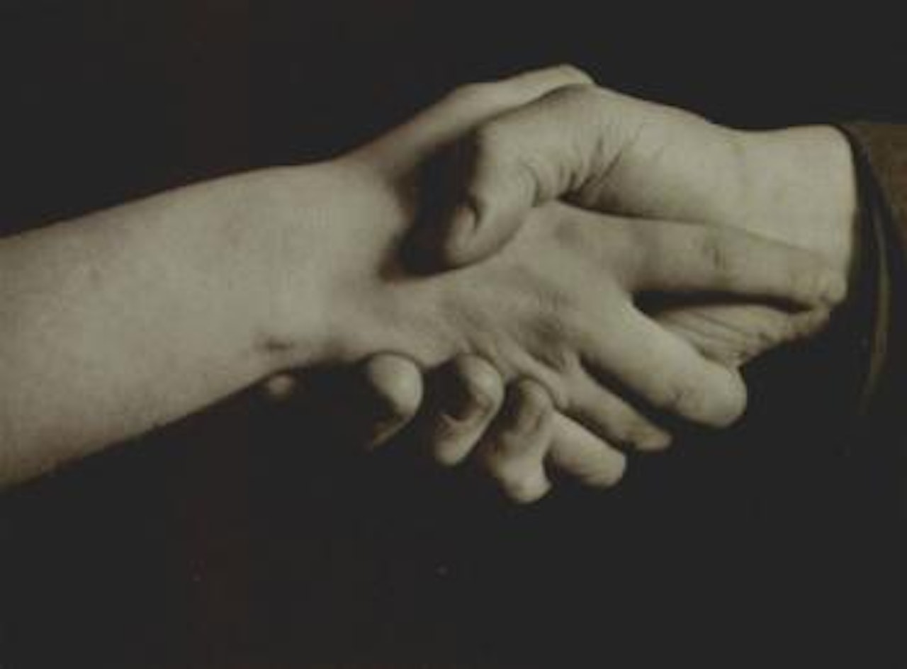 Hand of a girl, hand of a man by August Sander