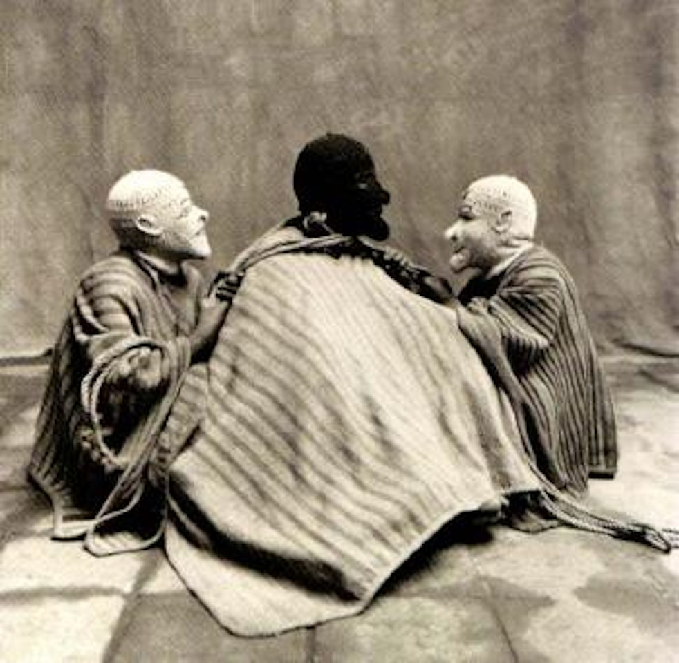 Three sitting men in masks, Cuzco, Mexico by Irving Penn