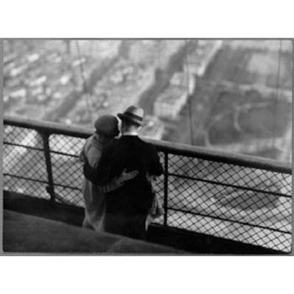 Couple embracing on the Eiffel Tower by André Kertész