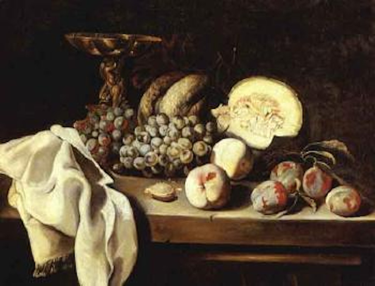 Gold tazza, grapes and other fruit partially draped table. Gold tazza, wine glass, wicker basket by Michele Pace del Campidoglio