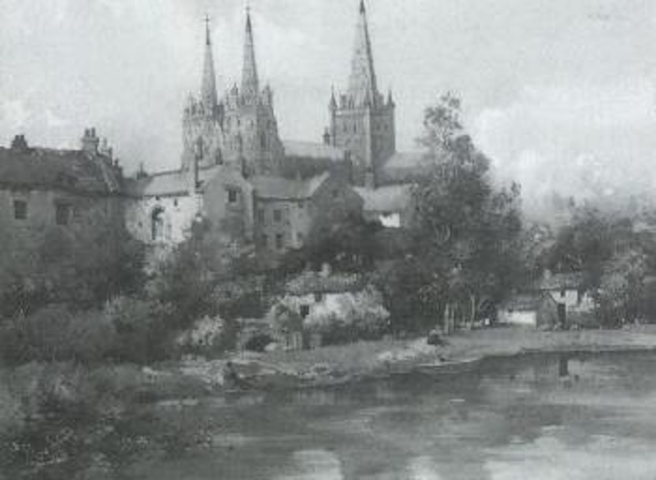 Continental town view with figures on riverbank by Noel Harry Leaver