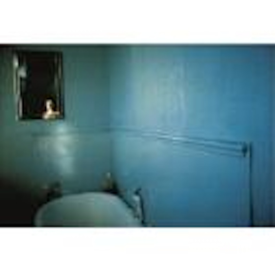 Self-portrait in blue bathroom by Nan Goldin
