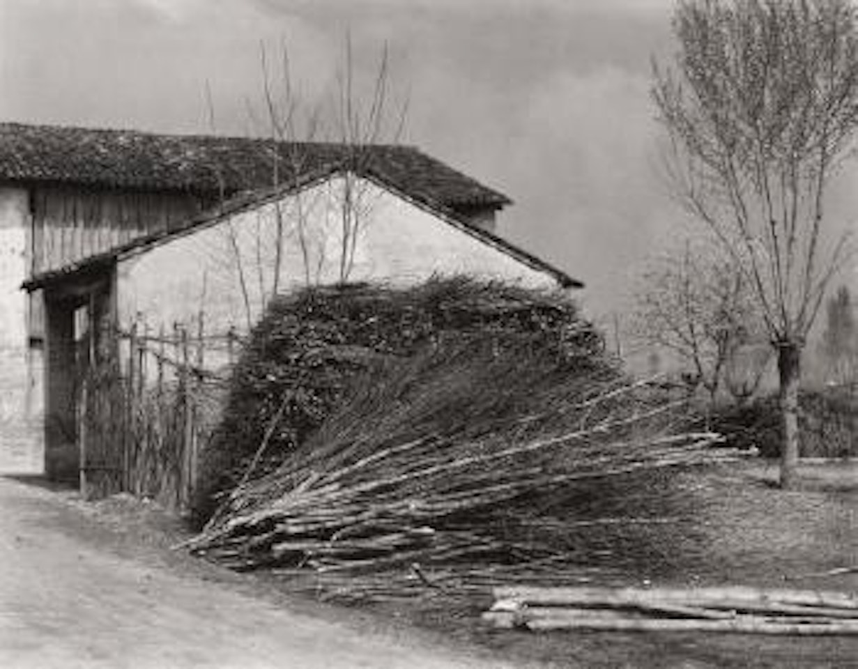 House and stacked brush, Luzzara, Italy by Paul Strand