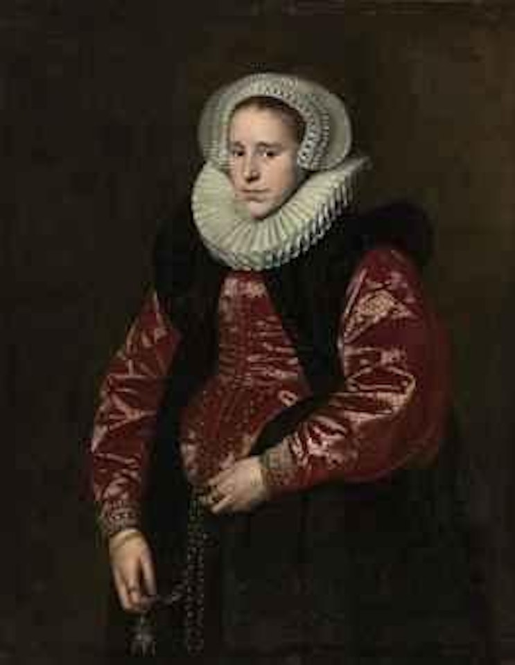 Portrait of a lady, half-length, in a lace bonnet, ruff, red gown with a black velvet mantle, holding a jewelled gold pomander by Paulus Moreelse