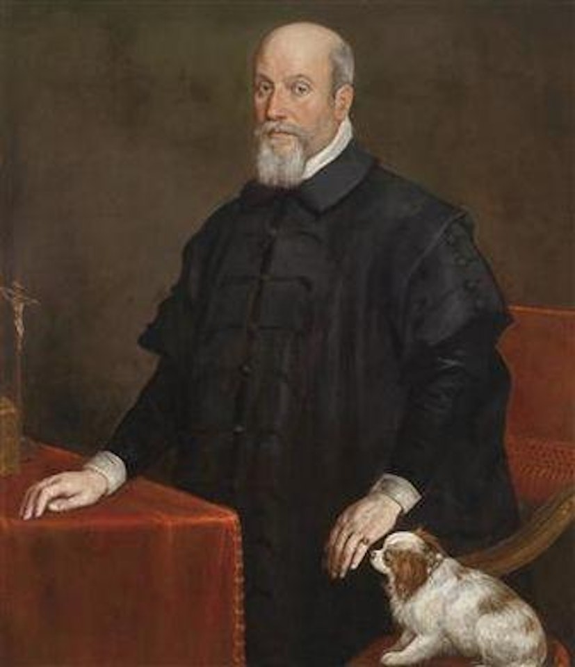 Portrait of a gentleman in a black cloak at a table with a crucifix, a lap dog at his side by Leandro Bassano