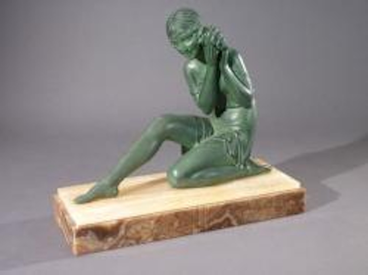 Une jeune femme drapée portant à son oreille un coquillage by Demetre Chiparus