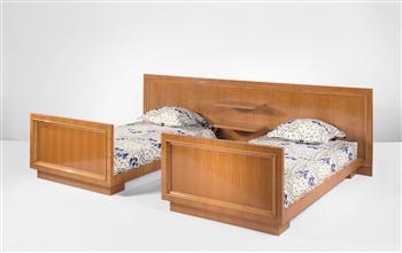 Pair of studded beds with integrated headboard by Jean Royere
