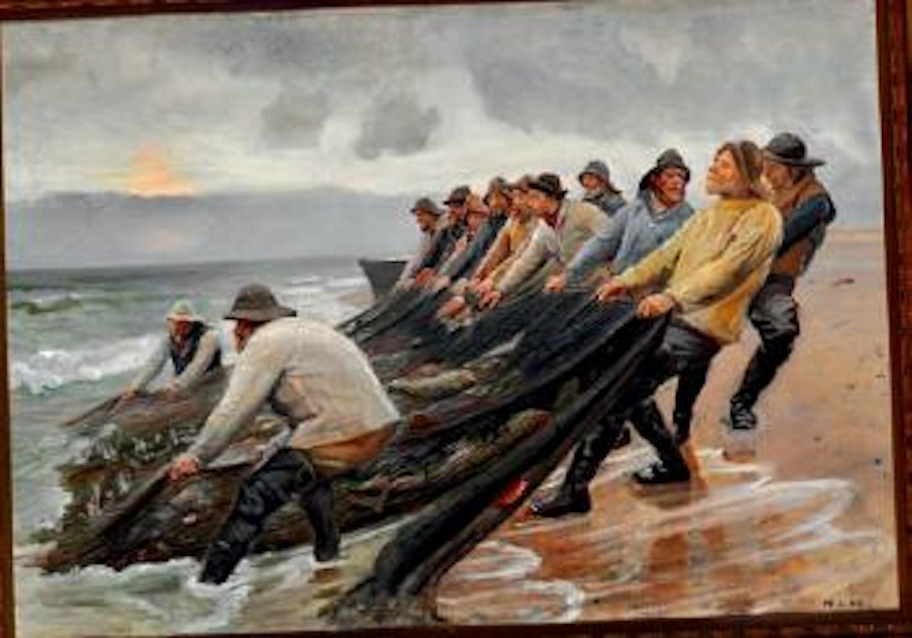 View of Skagen Beach with fishermen hauling in the fishing-nets by Michael Ancher