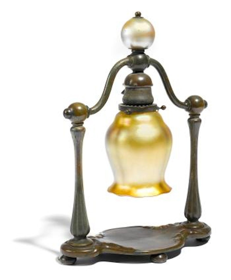 A Tiffany Studios patinated bronze and Quezal glass lamp by Tiffany Studios