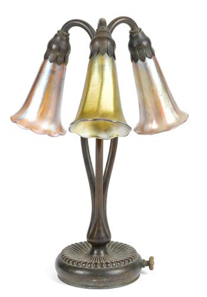 A Tiffany Studios Favrile glass and bronze three light lily lamp by Tiffany Studios