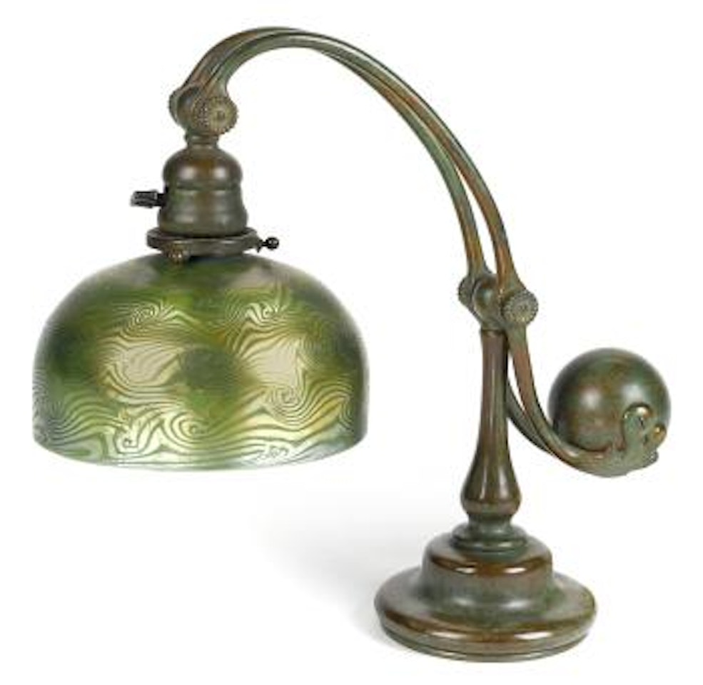 A Tiffany Studios Favrile glass and patinated bronze counterbalance desk lamp by Tiffany Studios