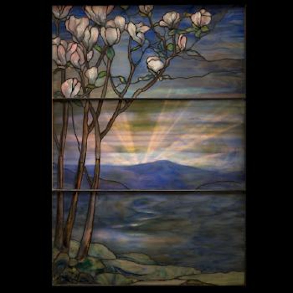 Flowering magnolia tree in the foreground of a serene landscape, with a a river meandering down from a mountainous pass to a lake by Tiffany Studios