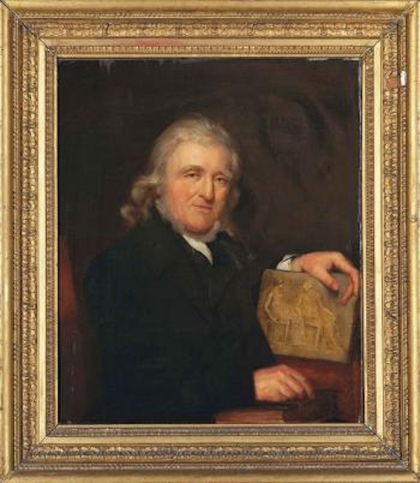 Portrait of John Henning (1771-1851), half-length, in a black coat, his right hand resting on a book by English School