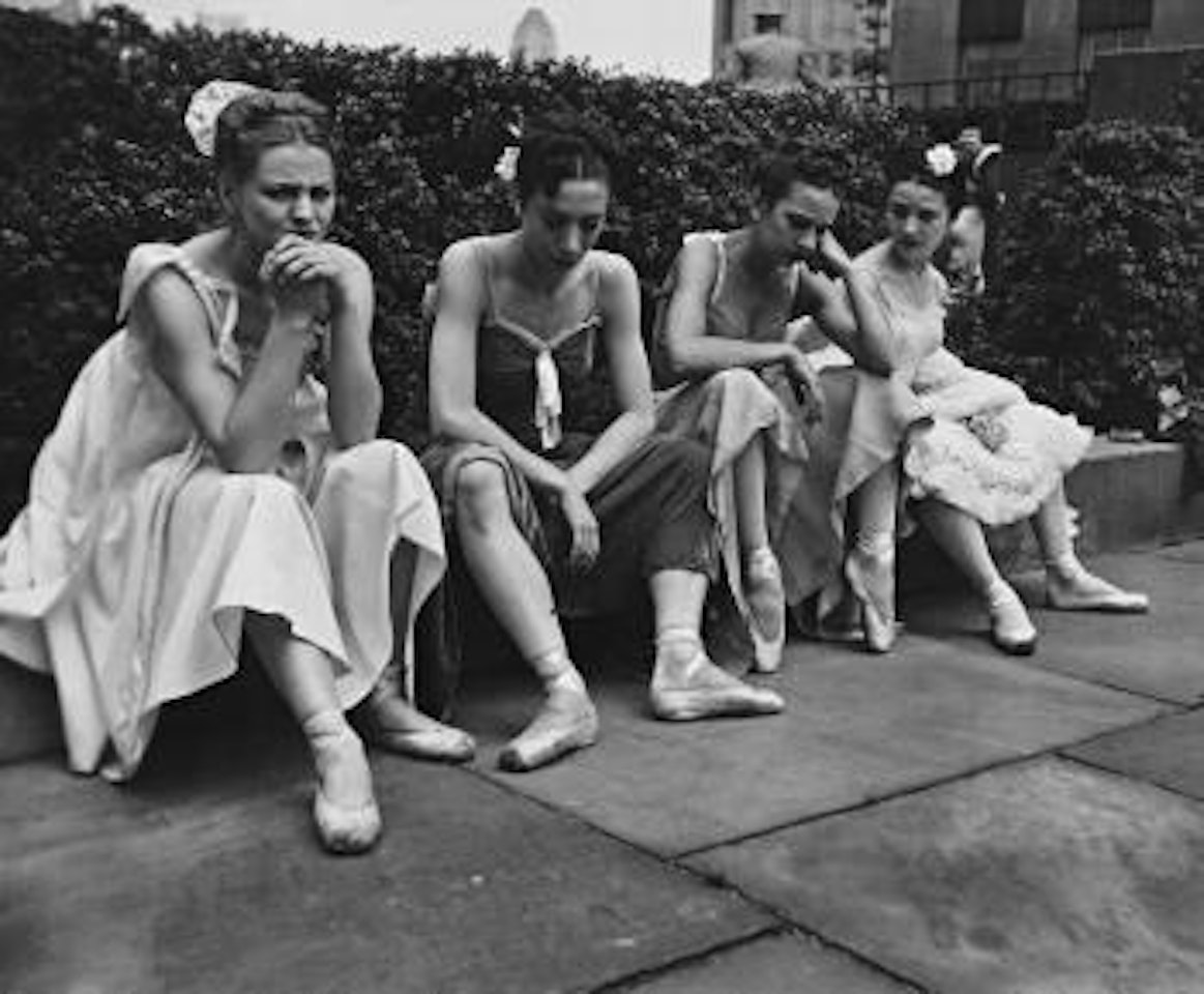 Ballet Dancers sitting on ledge, July by André Kertész