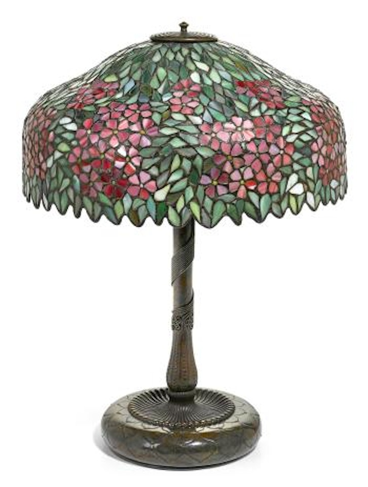 An American leaded glass shade and a Tiffany Studios patinated bronze base by Tiffany Studios