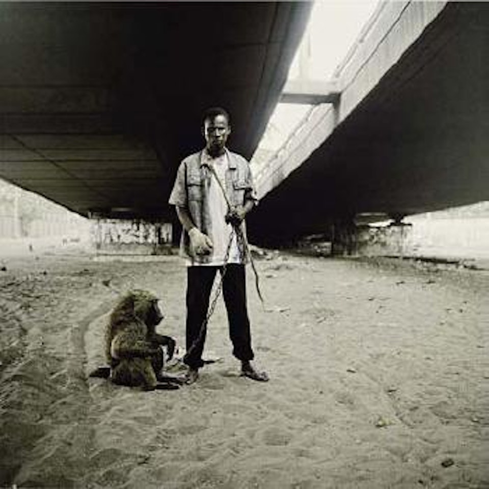 Animal handler with Ajusco, Lagos, Nigeria by Pieter Hugo