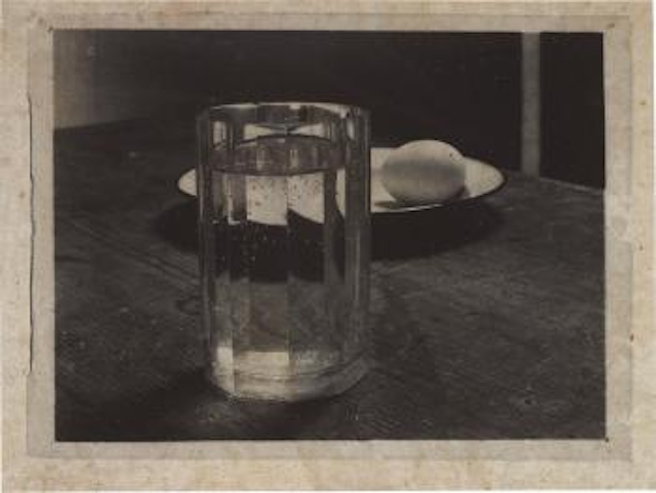 Glass and egg on a plate by Josef Sudek