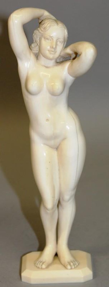 Standing nude, her arms behind her neck by Ferdinand Preiss