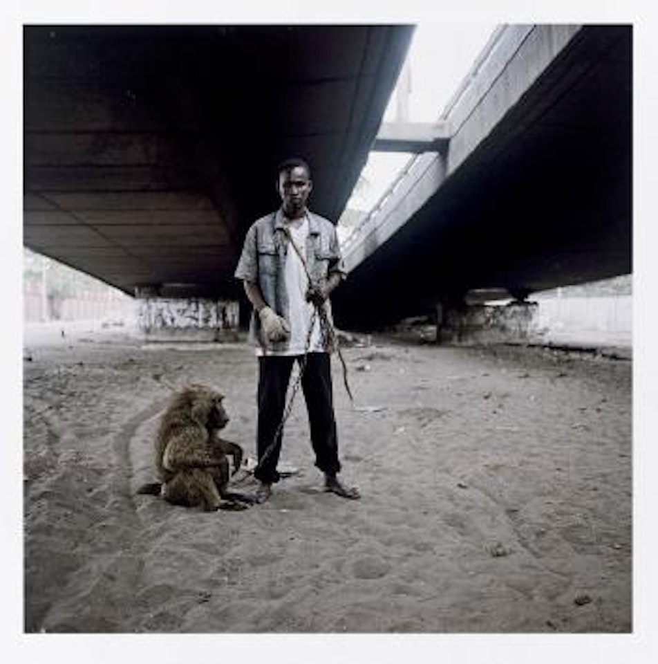 Animal handler with Ajusco, Lagos, Nigeria by Pieter Hugo