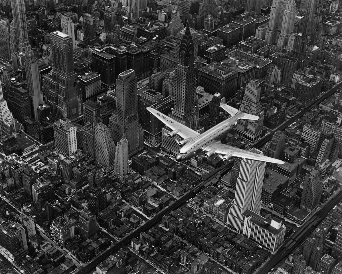 A DC-4 FLYING OVER NEW YORK CITY by Margaret Bourke-White