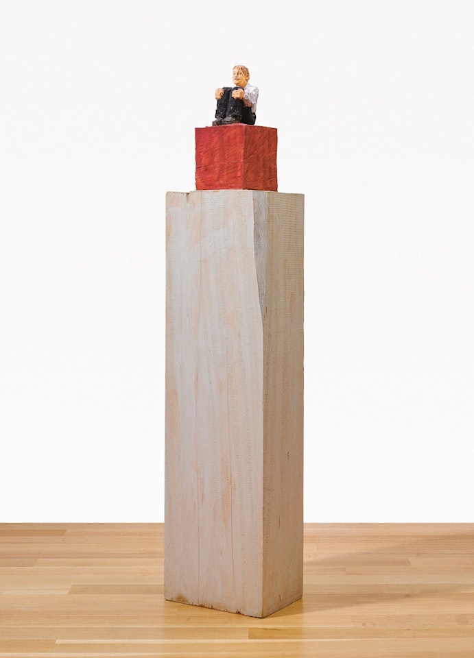 SMALL MAN SITTING ON CUBE by Stephan Balkenhol