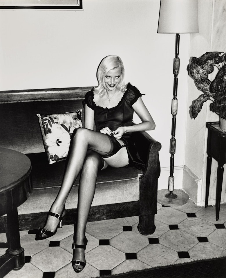 'NADJA ADJUSTING STOCKING', HOTEL BALMORAL, MONTE CARLO by Helmut Newton