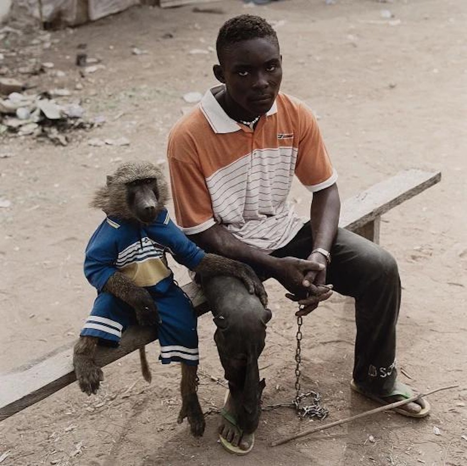 Dayaba Usman with the monkey Clear, Nigeria from The Hyena and Other Men by Pieter Hugo