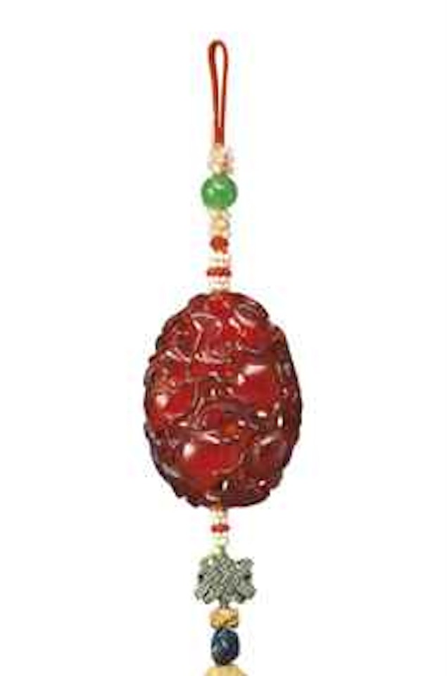 A RETICULATED AMBER 'POMEGRANATE' PENDANT by Anonymous