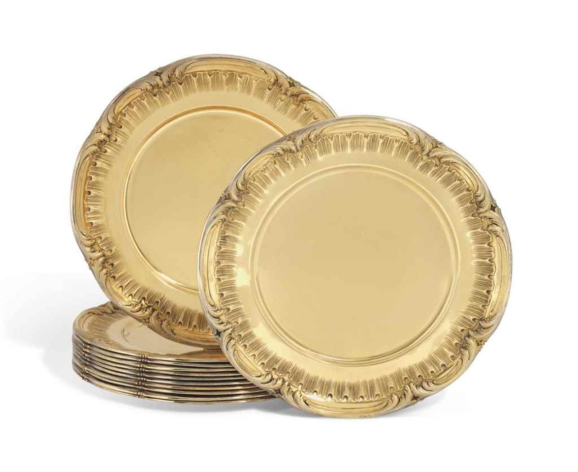 A FRENCH SET OF TWELVE SILVER-GILT UNDER-PLATES by Anonymous