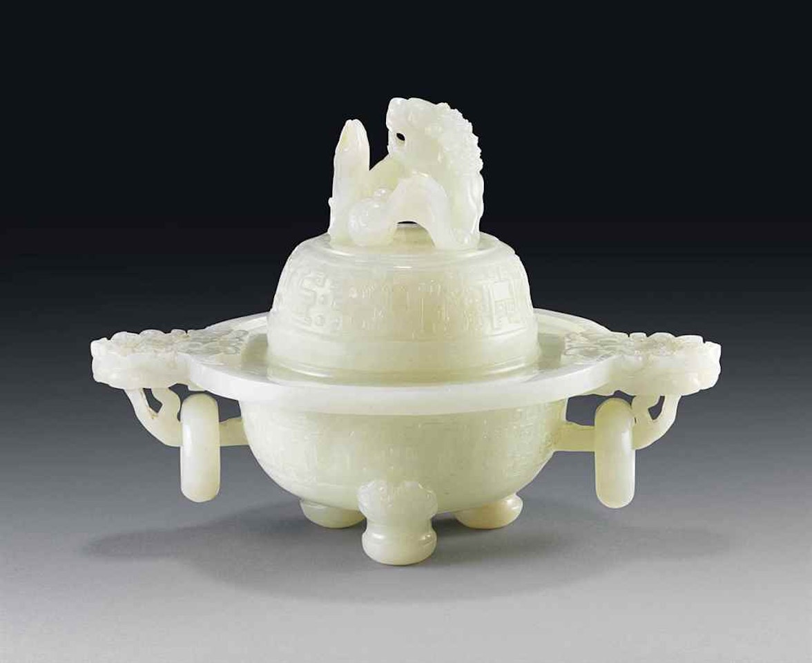 A WHITE JADE 'BUDDHIST LION' TWIN-HANDLED CENSER AND COVER by Anonymous