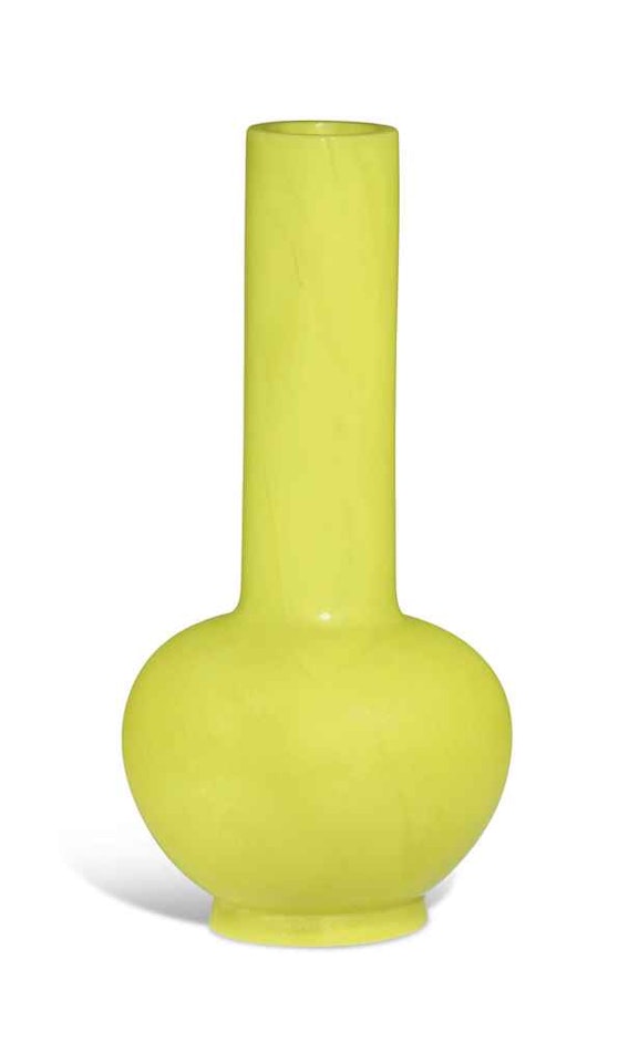 A YELLOW GLASS BOTTLE VASE by Anonymous