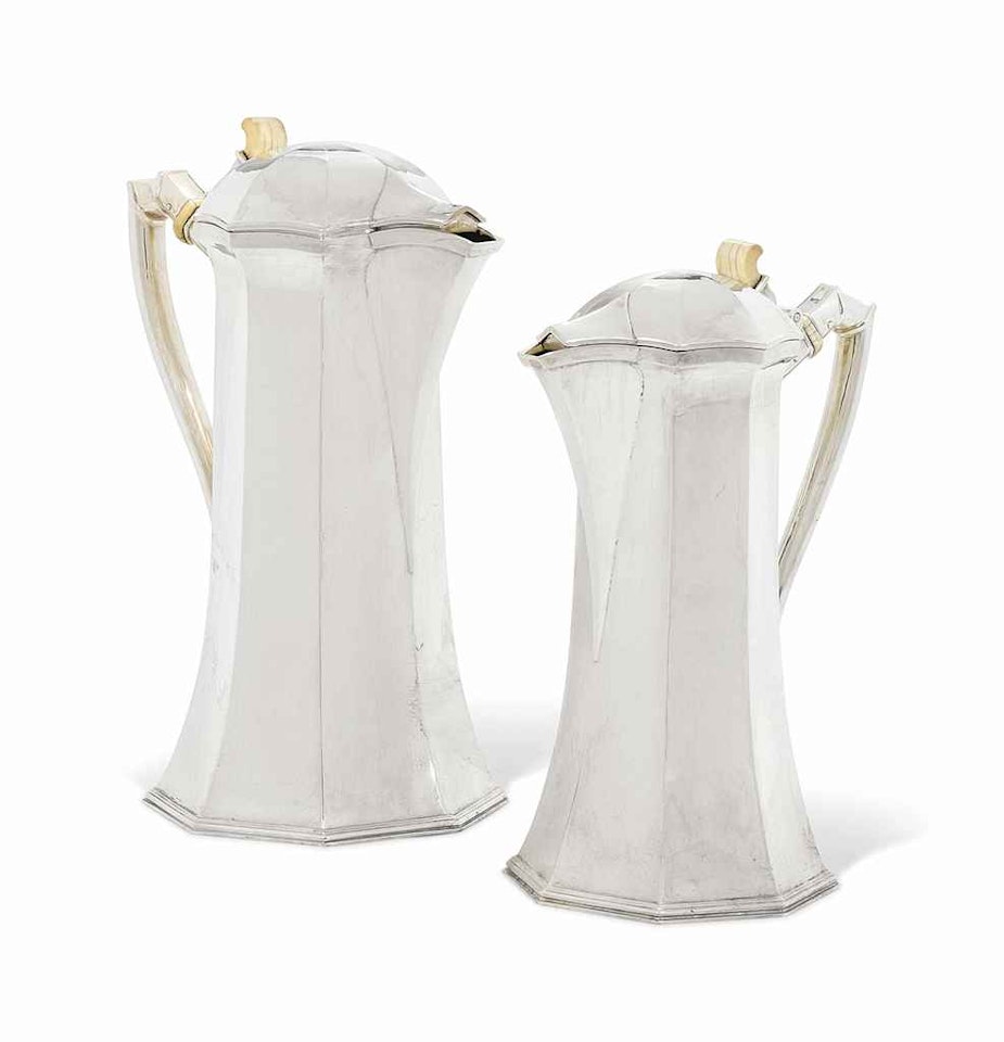 A PAIR OF GEORGE VI GRADUATED SILVER HOT WATER-JUGS by Anonymous