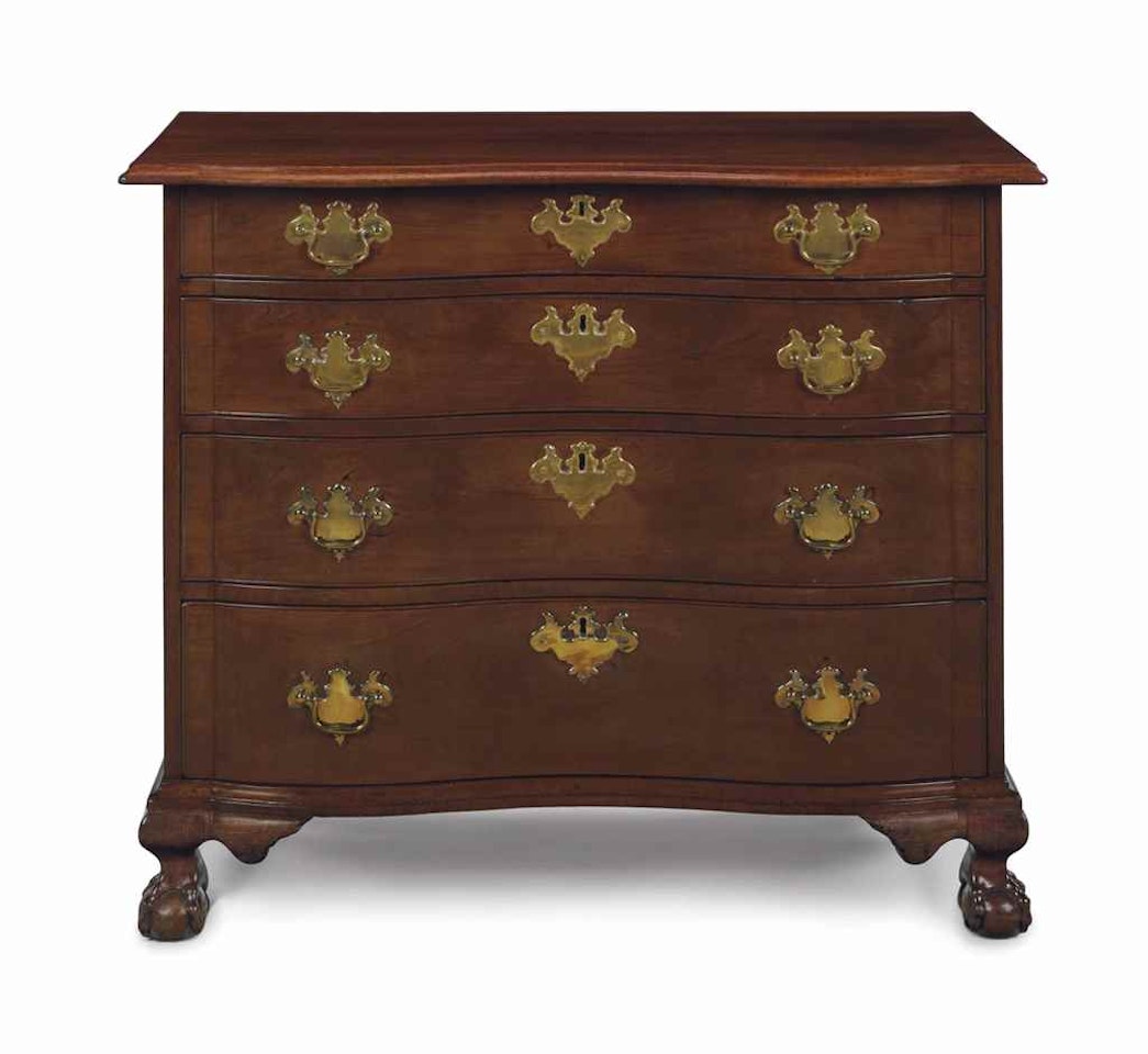 A CHIPPENDALE CARVED MAHOGANY BLOCKED REVERSE-SERPENTINE CHEST-OF-DRAWERS by Anonymous